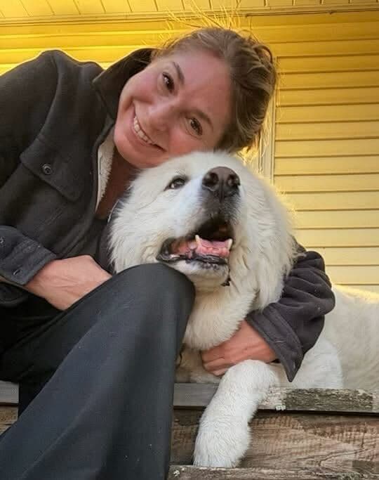 Laura with Henry, the Great Pyrenees who inspired PetCare Alley